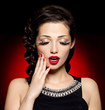 Young pretty woman with red manicure and  lips