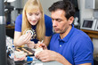 Two dental technicians choosing the right colour for dental porc