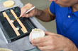 Closeup of dental technician applying porcelain