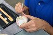 Closeup of dental technician applying porcelain