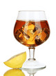 Glass of brandy with ice and lemon isolated on white