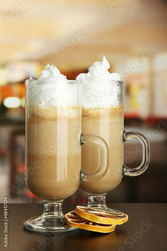 Photo: Fragrant coffee latte in glasses cups with dry orange, Fragrant coffee latte in glasses cups with dry orange,