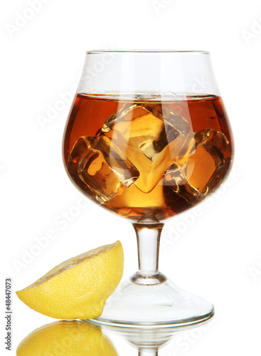 Photo: Glass of brandy with ice and lemon isolated on white Glass of brandy with ice and lemon isolated on white