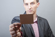 Photo: Businessman holding blank card Businessman holding blank card