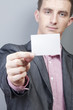 Photo: Businessman holding blank card Businessman holding blank card