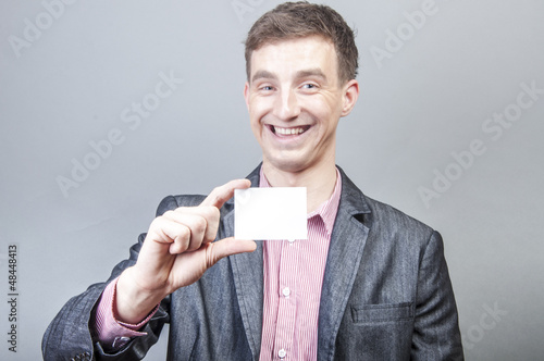 Photo: Businessman holding blank card Businessman holding blank card