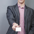 Photo: Businessman holding blank card Businessman holding blank card