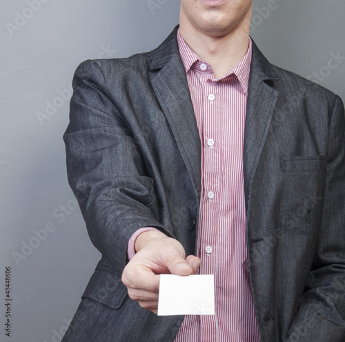 Photo: Businessman holding blank card Businessman holding blank card