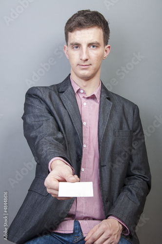 Photo: Businessman holding blank card Businessman holding blank card