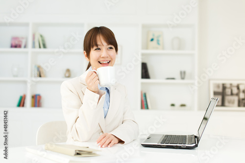 Photo: Beautiful young businesswoman working in office Beautiful young businesswoman working in office