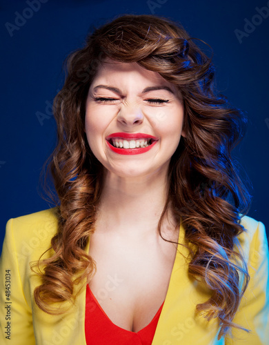 Photo: Portrait of an attractive young woman laughing hard Portrait of an attractive young woman laughing hard