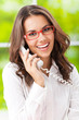 Young woman with phone, at office