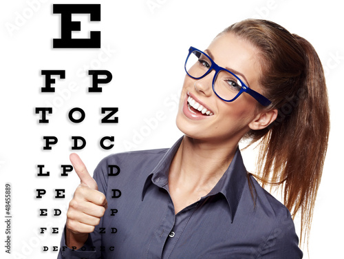 Photo: beautiful woman with blue trendy glasses on the background of e beautiful woman with blue trendy glasses on the background of e