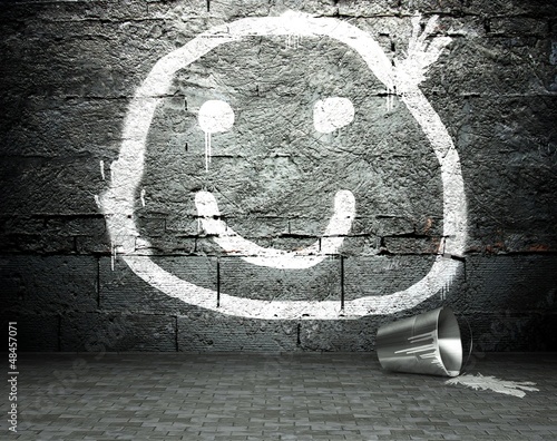 Photo: Graffiti wall with smile face, street background Graffiti wall with smile face, street background
