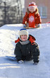 Foto: Children slide down icy hill Children slide down icy hill