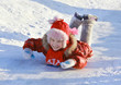 Foto: Girl sliding down a frozen hill Girl sliding down a frozen hill