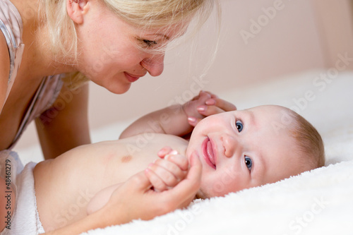 Photo: loving mother playing with her baby boy loving mother playing with her baby boy