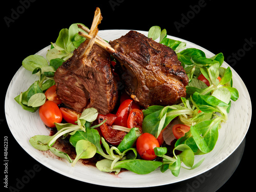 Photo: Rare fried rack of lamb isolated on black Rare fried rack of lamb isolated on black
