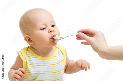 Photo: Little baby feeding with a spoon Little baby feeding with a spoon