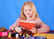 happy girl at the desk on blue background