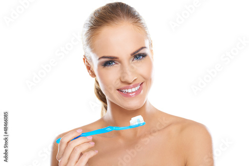 Photo: Beautiful woman with a toothbrush and paste Beautiful woman with a toothbrush and paste