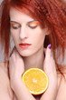 portrait of redhaired woman with orange half