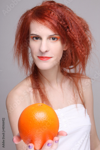 Photo: portrait of redhaired girl with orange portrait of redhaired girl with orange