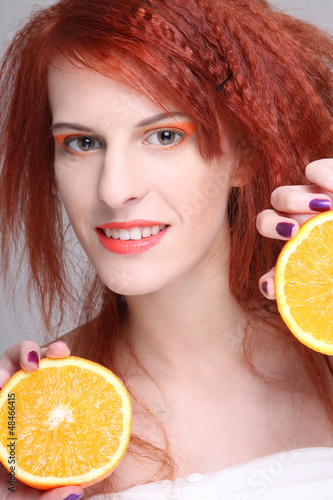 Photo: redhaired woman with orange half redhaired woman with orange half