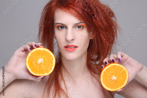 Photo: redhaired girl with orange half redhaired girl with orange half