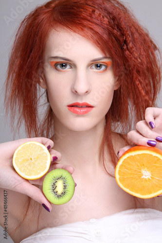Photo: redhaired girl with orange, lemon and kiwi redhaired girl with orange, lemon and kiwi