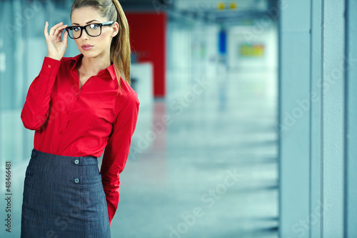 Photo: A portrait of a young business woman in an office A portrait of a young business woman in an office