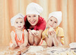Photo: Mother with two daughters baking bread. Mother with two daughters baking bread.