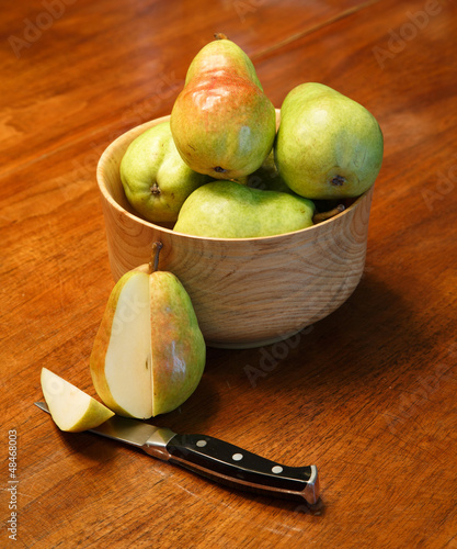 Photo: Cut Pear with Pears in Wood Bowl Cut Pear with Pears in Wood Bowl
