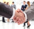 Closeup of business people shaking hands over a deal