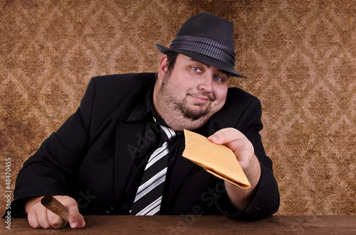 Photo: Gangster holding brown envelope Gangster holding brown envelope