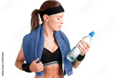Photo: Woman Looking at a Bottle of Water Woman Looking at a Bottle of Water