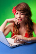 Portrait of smiling young woman working on a laptop