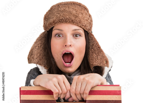 Photo: Winter woman posing at white background with shopping bag and op Winter woman posing at white background with shopping bag and op