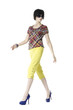 Fashion girl wearing sunglasses walking in studio