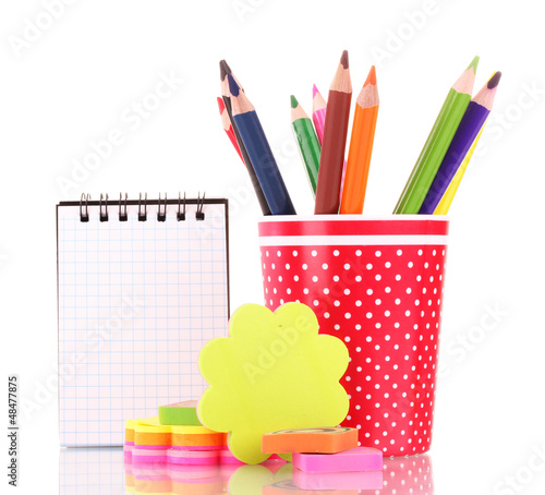 Photo: red glass with colorful pencils and stationery isolated on red glass with colorful pencils and stationery isolated on