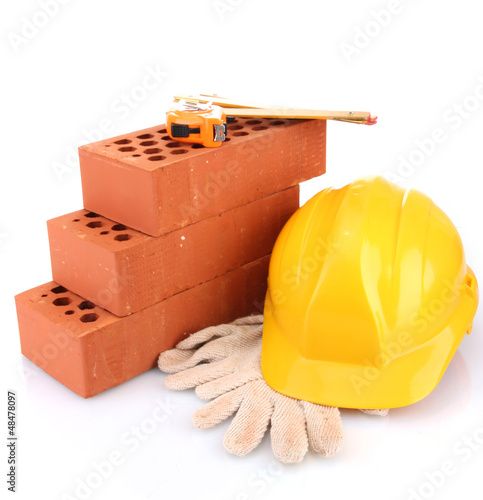 Photo: helmet, roulette, bricks and gloves isolated on white helmet, roulette, bricks and gloves isolated on white