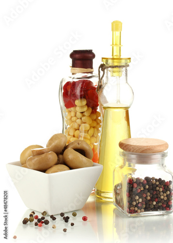 Photo: Delicious marinated mushrooms in bowl with spices isolated Delicious marinated mushrooms in bowl with spices isolated