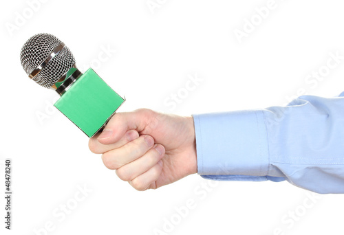 Photo: Male hand with microphone isolated on white Male hand with microphone isolated on white