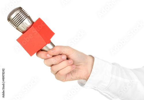 Photo: Female hand with microphone isolated on white Female hand with microphone isolated on white
