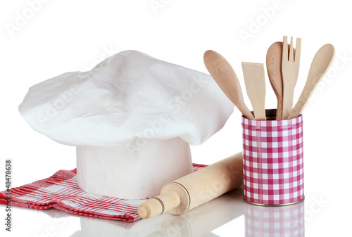 Photo: Chef's hat with spoons and battledore isolated on white Chef's hat with spoons and battledore isolated on white