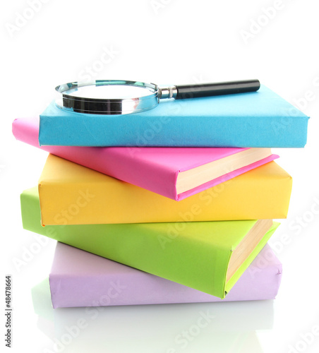 Photo: color books with magnifying glass isolated on white color books with magnifying glass isolated on white