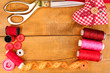Sewing accessories and fabric on wooden table close-up