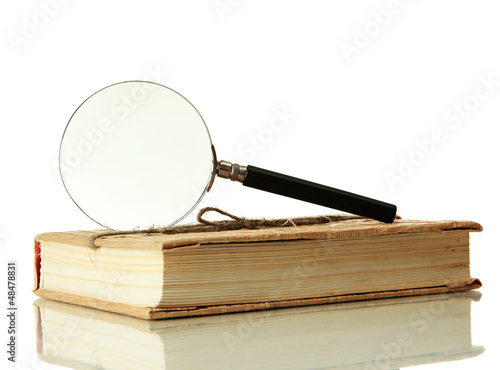 Photo: Magnifying glass and book isolated on white Magnifying glass and book isolated on white