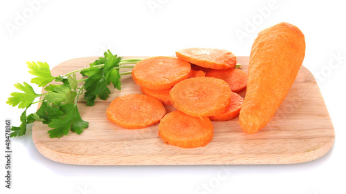 Photo: carrots on cutting board isolated on white carrots on cutting board isolated on white