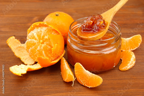 Photo: tasty homemade mandarine jam, on wooden table tasty homemade mandarine jam, on wooden table